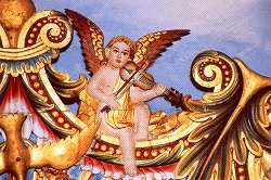 Angel playing a five-stringed violin on a Harp